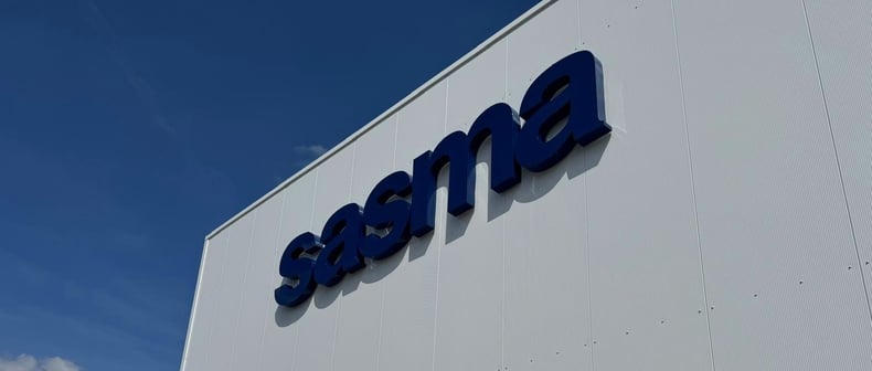 The Sasma logo against a white wall