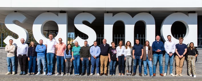 The Sasma Team Stands Outside of Sasma's Headquarters